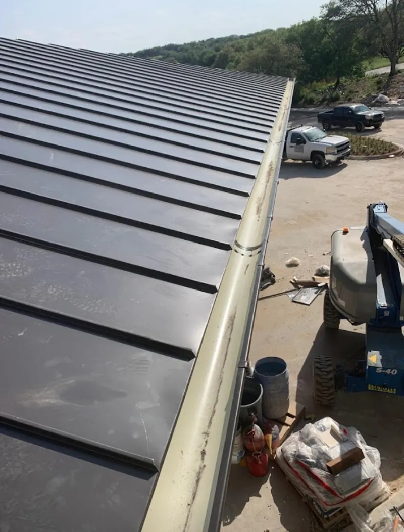 Standing seam panel and gutter detail on a metal roofing jobsite in Napa